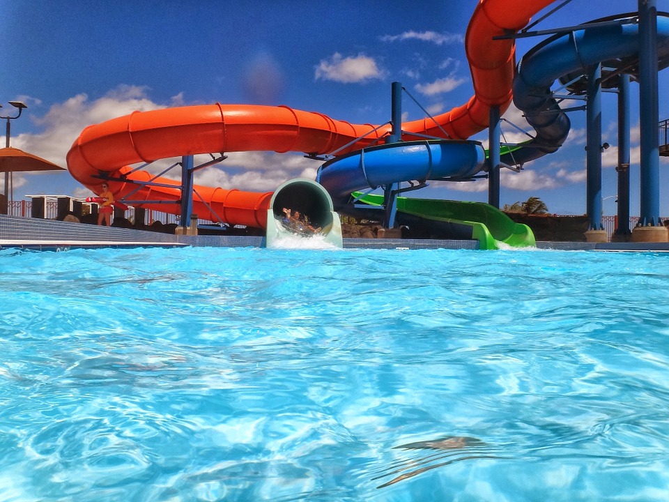 An orange and blue waterslide and pool at a waterpark. | Local attractions in Jacksonville, AR.