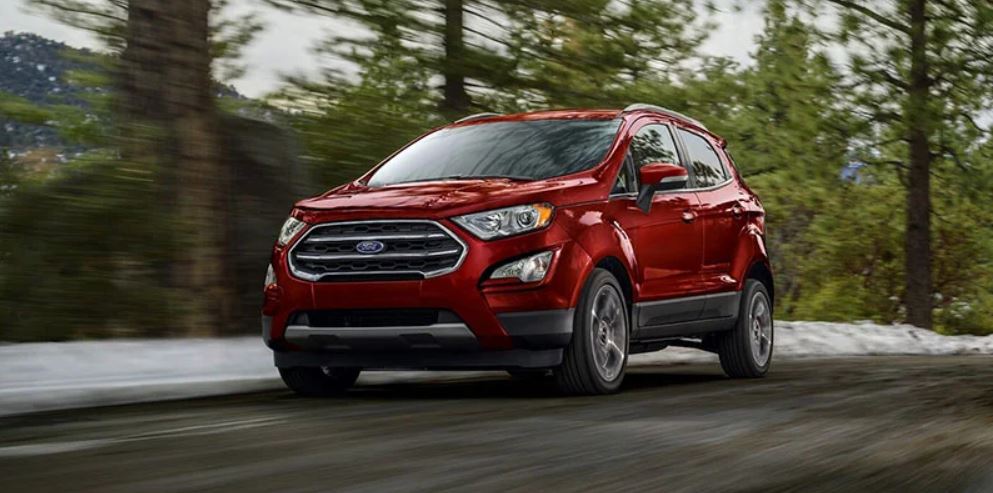 Red 2021 Ford EcoSport being driven on the highway with trees in the background. | Ford service center in Jacksonville, AR.