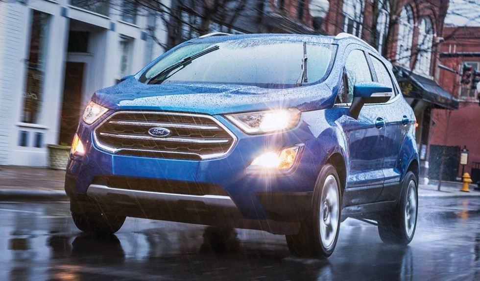 A blue 2021 Ford EcoSport being driven on the road in the rain. | Ford service center in Jacksonville, AR.