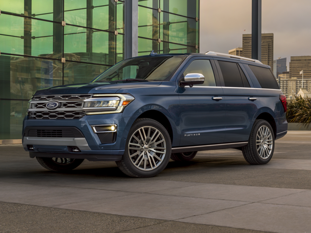 Front profile view of a dark blue 2023 Ford Expedition parked in front of a building with walls of glass. | Ford Dealer | Crain Ford of Jacksonville